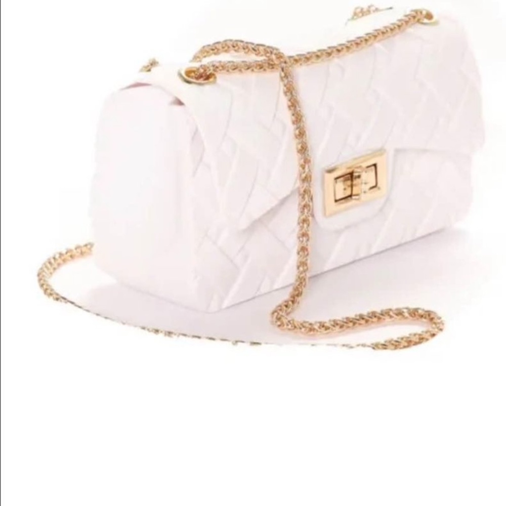 White bag with a gold chain strap